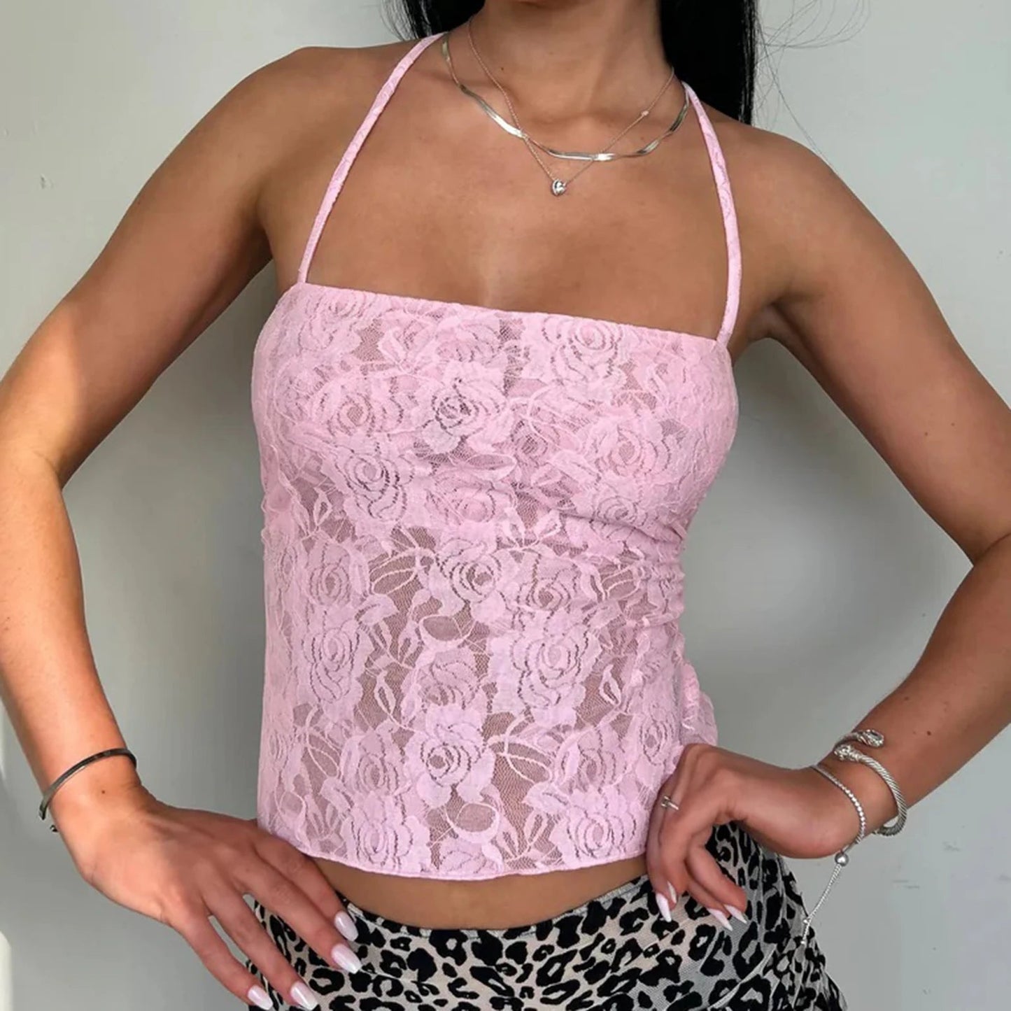 Elevate your summer wardrobe with the Gaono Women Lace Camisole, a chic blend of elegance and allure. This stunning crop top features delicate lace detailing, a sexy backless design, and trendy cross lacing for a fashionable touch. Perfect for