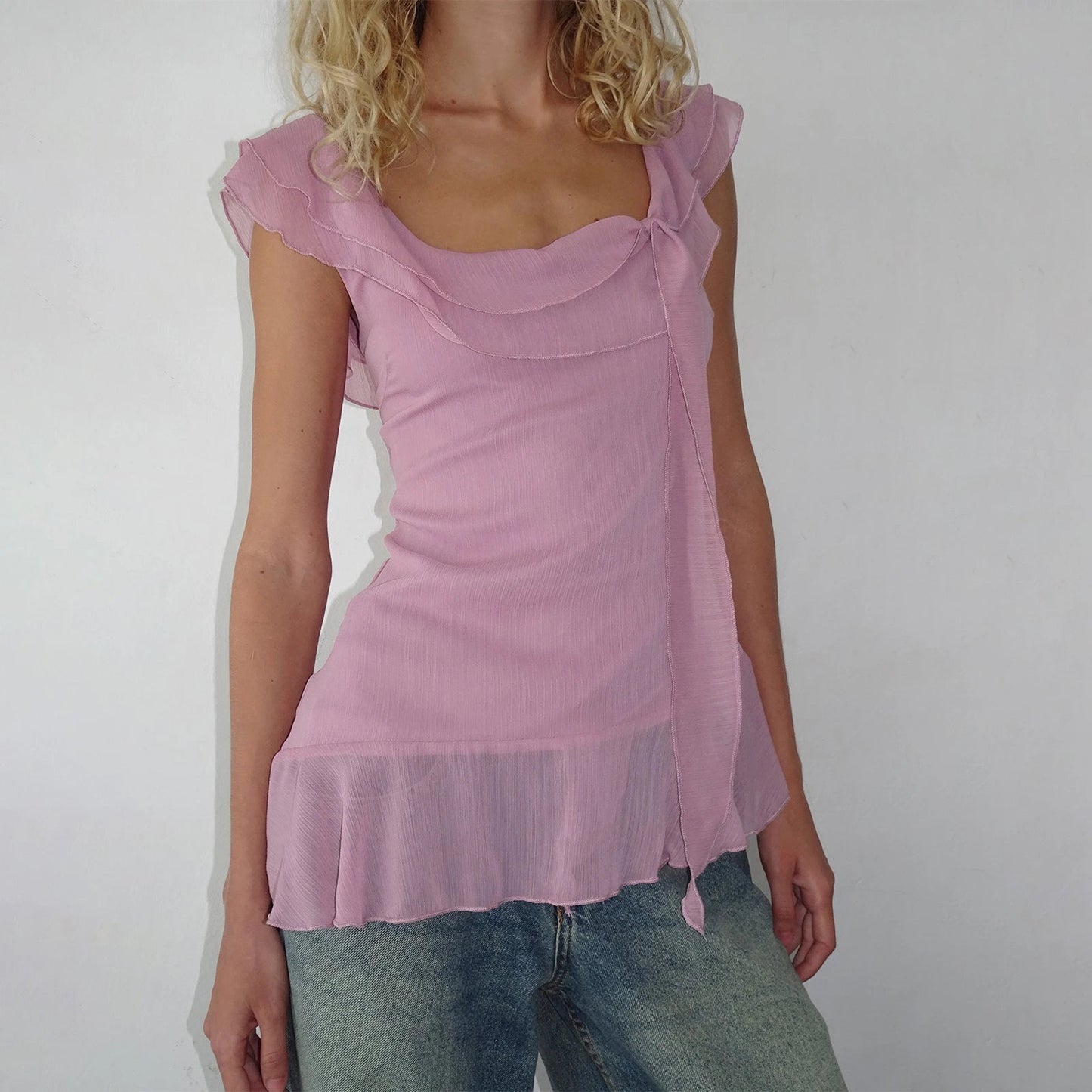 Elevate your summer look with the Gaono Y2K Fairy Crop Top! This charming ruffle-trim tank top features a square neck design and lightweight chiffon, perfect for staying stylish on sunny days. Made from a soft cotton and polyester blend,