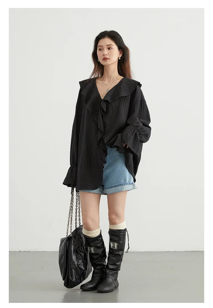 Elevate your spring and summer wardrobe with the Ruffled V-Neck Lace-Up Blouse. This stylish blouse features a beautiful ruffled V-neckline and playful lace-up detailing, offering an adjustable fit. Its loose design ensures breathability and comfort on