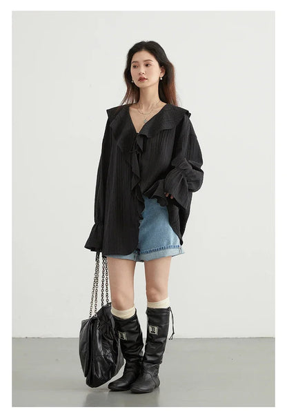 Elevate your spring and summer wardrobe with the Ruffled V-Neck Lace-Up Blouse. This stylish blouse features a beautiful ruffled V-neckline and playful lace-up detailing, offering an adjustable fit. Its loose design ensures breathability and comfort on