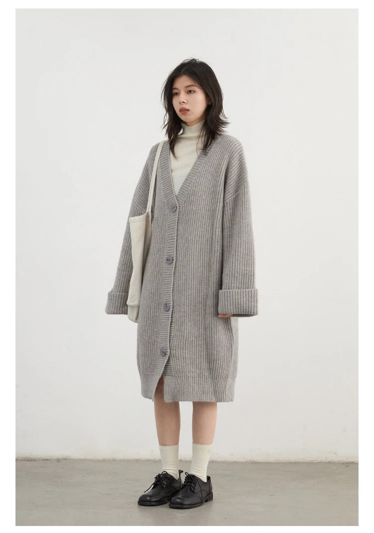 Effortlessly chic Korean Loose Knitted Cardigan & Long Coat, crafted from luxuriously soft knitted fabric for ultimate comfort. This oversized piece features a timeless button closure, making it perfect for layering. Available in neutral colors, it seamlessly integrates into
