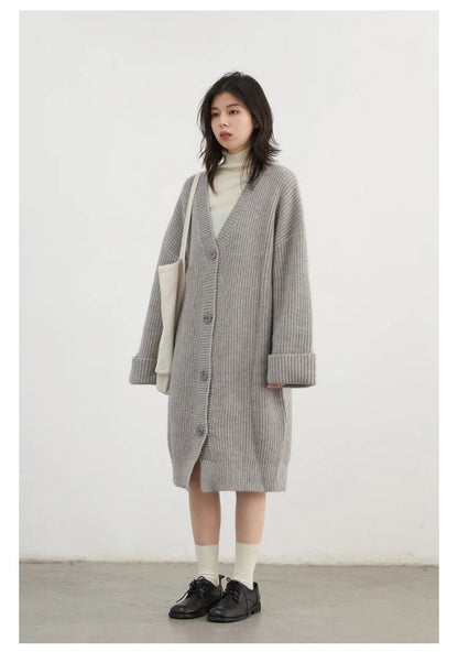 Effortlessly chic Korean Loose Knitted Cardigan & Long Coat, crafted from luxuriously soft knitted fabric for ultimate comfort. This oversized piece features a timeless button closure, making it perfect for layering. Available in neutral colors, it seamlessly integrates into