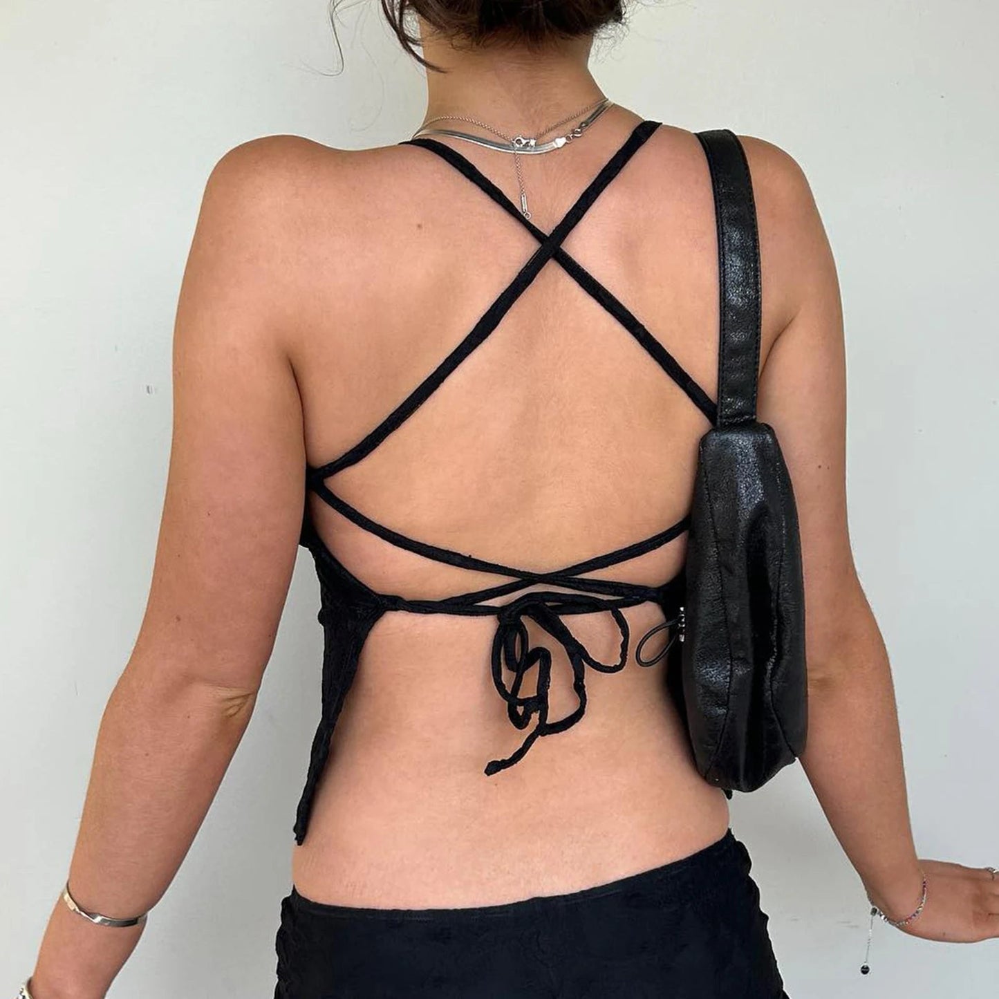 Elevate your summer wardrobe with the Gaono Women Lace Camisole! This chic backless crop top features intricate lace detailing and stylish cross lacing for a flirty touch. Crafted from lightweight, non-stretch broadcloth fabric, it's perfect for