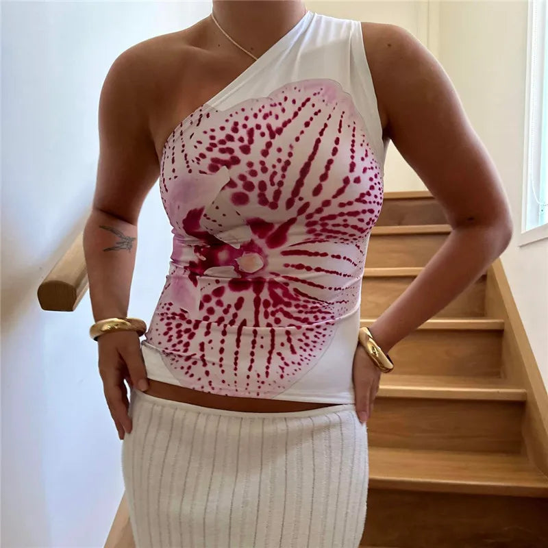 Elevate your summer style with the Gaono Floral Print Fitted Top! This chic one-shoulder tank top showcases a vibrant floral design, perfect for resort wear or casual outings. Crafted from a soft, breathable cotton-polyester blend, it offers