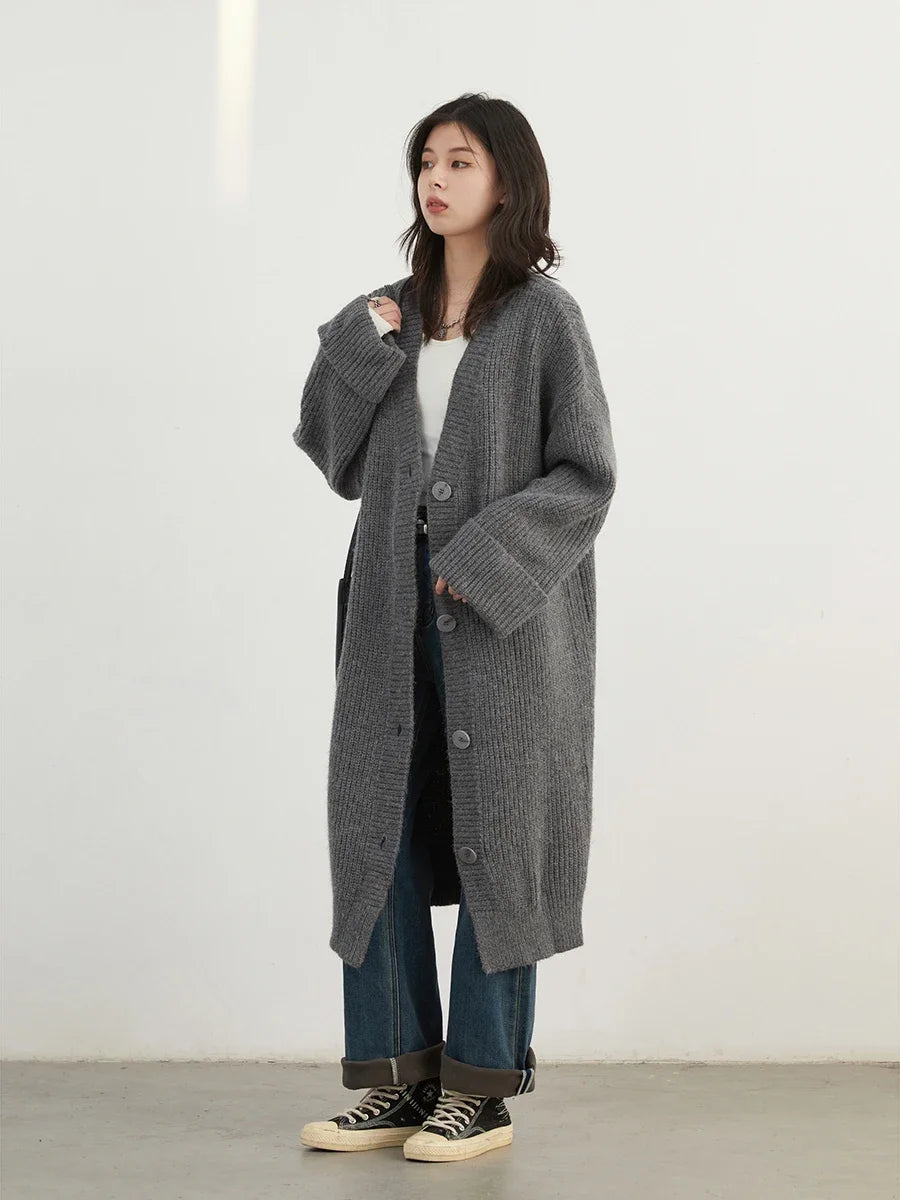 Effortlessly stylish Korean Loose Knitted Cardigan & Long Coat, crafted from luxuriously soft knitted fabric for ultimate comfort. This oversized, cozy piece features a timeless button closure, making it perfect for layering on any occasion. Available in neutral tones
