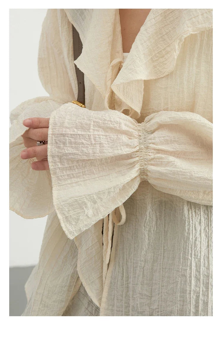 Elevate your spring and summer wardrobe with the Ruffled V-Neck Lace-Up Blouse. This stylish blouse features a beautifully ruffled neckline and playful lace-up detailing for an adjustable fit. Crafted with a loose and breathable design, it ensures comfort during