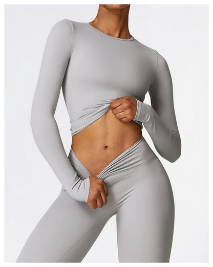 Elevate your fitness wardrobe with the NCLAGEN Yoga Shirt! This stylish long-sleeve top is crafted from a quick-dry, breathable nylon and spandex blend, offering exceptional comfort for yoga, running, and gym sessions. With its flattering