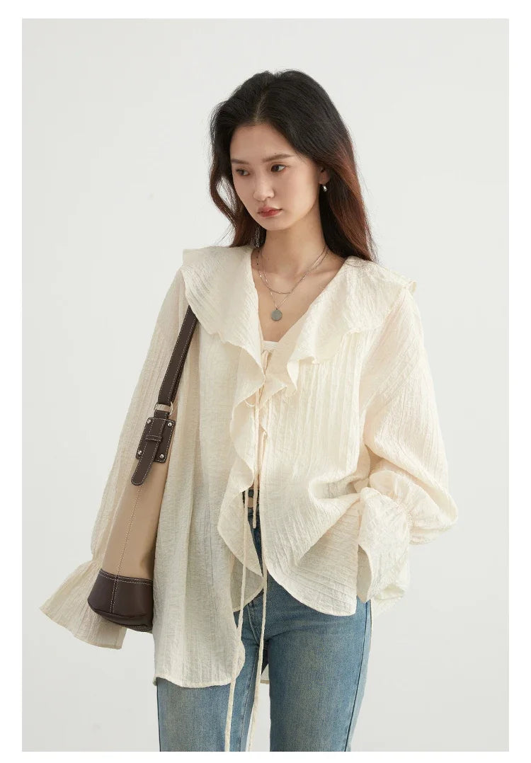 Effortlessly chic ruffled V-neck lace-up blouse designed for the modern woman. This stylish top features a beautiful ruffled neckline and adjustable lace-up detailing, ensuring a perfect fit. Made from breathable fabric, it offers comfort during warm spring and summer