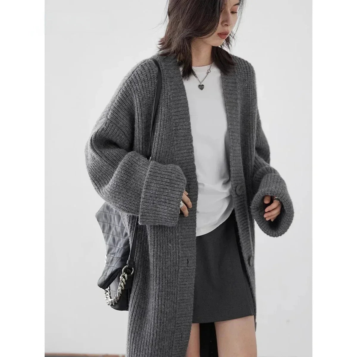 Discover the ultimate in comfort and style with our Korean Loose Knitted Cardigan & Long Coat. Crafted from luxuriously soft knitted fabric, this oversized cardigan offers a relaxed silhouette that flatters every figure. With its timeless design and button closure, it's