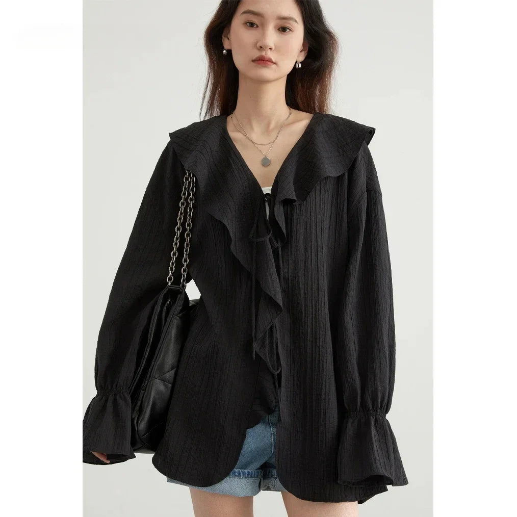 Effortlessly chic Ruffled V-Neck Lace-Up Blouse, perfect for spring and summer. This stylish top features a beautiful ruffled neckline and playful lace-up detailing for an adjustable fit. With a loose fit design for ultimate comfort and breathability