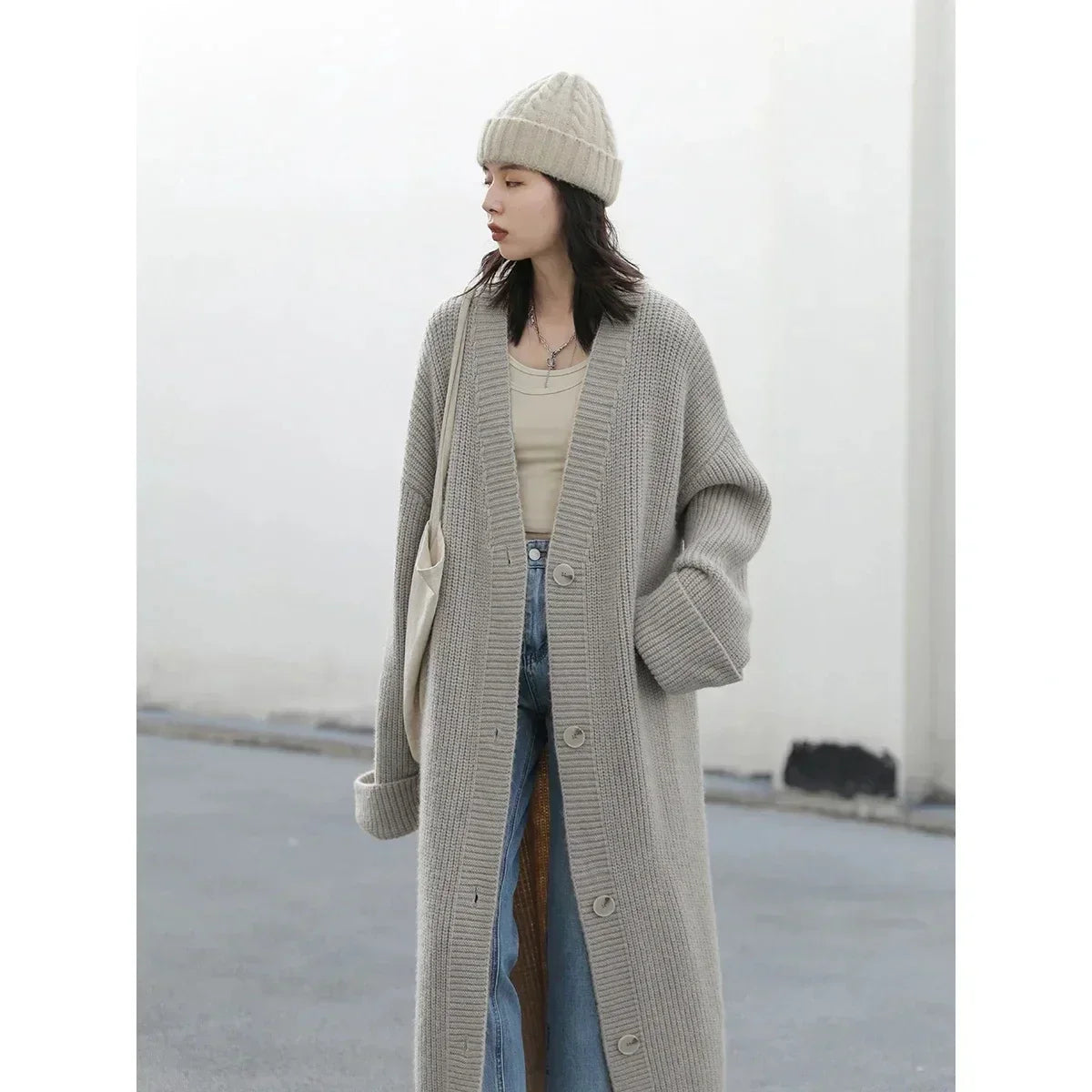 Effortlessly chic Korean Loose Knitted Cardigan & Long Coat, crafted from luxuriously soft fabric for ultimate comfort. This oversized piece features a timeless button closure, making it perfect for layering. Available in neutral tones, it seamlessly complements any outfit