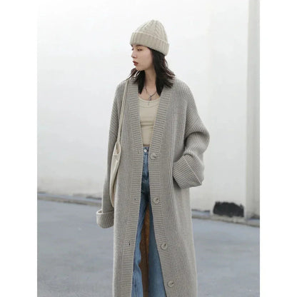 Effortlessly chic Korean Loose Knitted Cardigan & Long Coat, crafted from luxuriously soft fabric for ultimate comfort. This oversized piece features a timeless button closure, making it perfect for layering. Available in neutral tones, it seamlessly complements any outfit