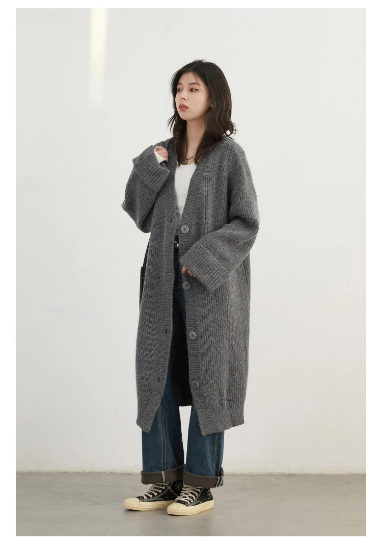 Elevate your wardrobe with the Korean Loose Knitted Cardigan & Long Coat, a perfect blend of comfort and style. This oversized cardigan features luxuriously soft knitted fabric, ideal for layering. With its timeless button closure and relaxed silhouette, it flat