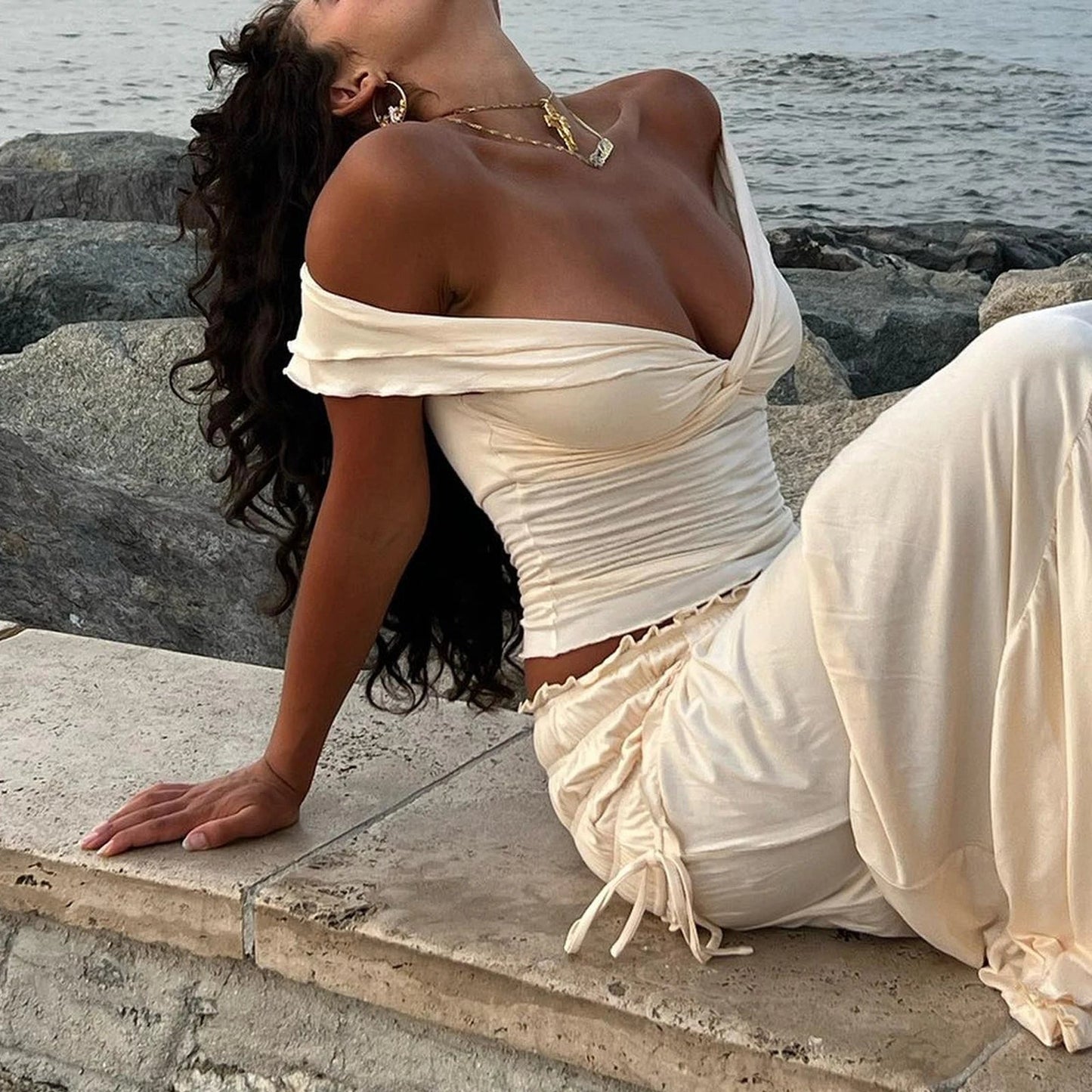 Discover the Gaono Women's Lettuce Trim Crop Top, a chic off-shoulder piece that combines a trendy twist knot design with a flattering fit. Crafted from soft polyester broadcloth with slight stretch, this stylish top offers all-day comfort. Perfect for