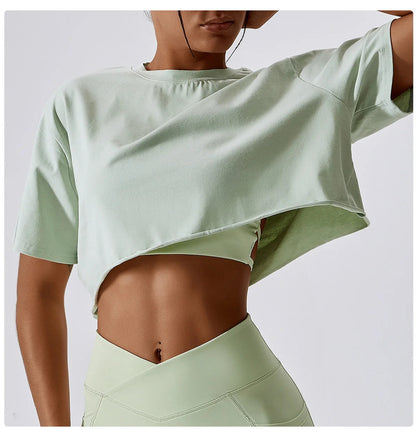 Stylish crop top in a refreshing mint green hue, crafted from soft, breathable cotton and spandex for ultimate comfort. Perfect for yoga, dance, or running, this loose-fit T-shirt offers unrestricted movement and quick-dry technology. Elevate your