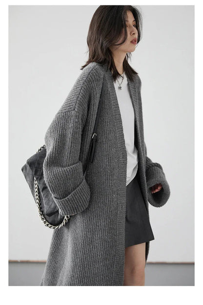 Step into effortless elegance with our Korean Loose Knitted Cardigan & Long Coat. Crafted from luxuriously soft knitted fabric, this oversized cardigan offers a cozy, relaxed silhouette that flatters every figure. Featuring a timeless button closure and available in neutral colors