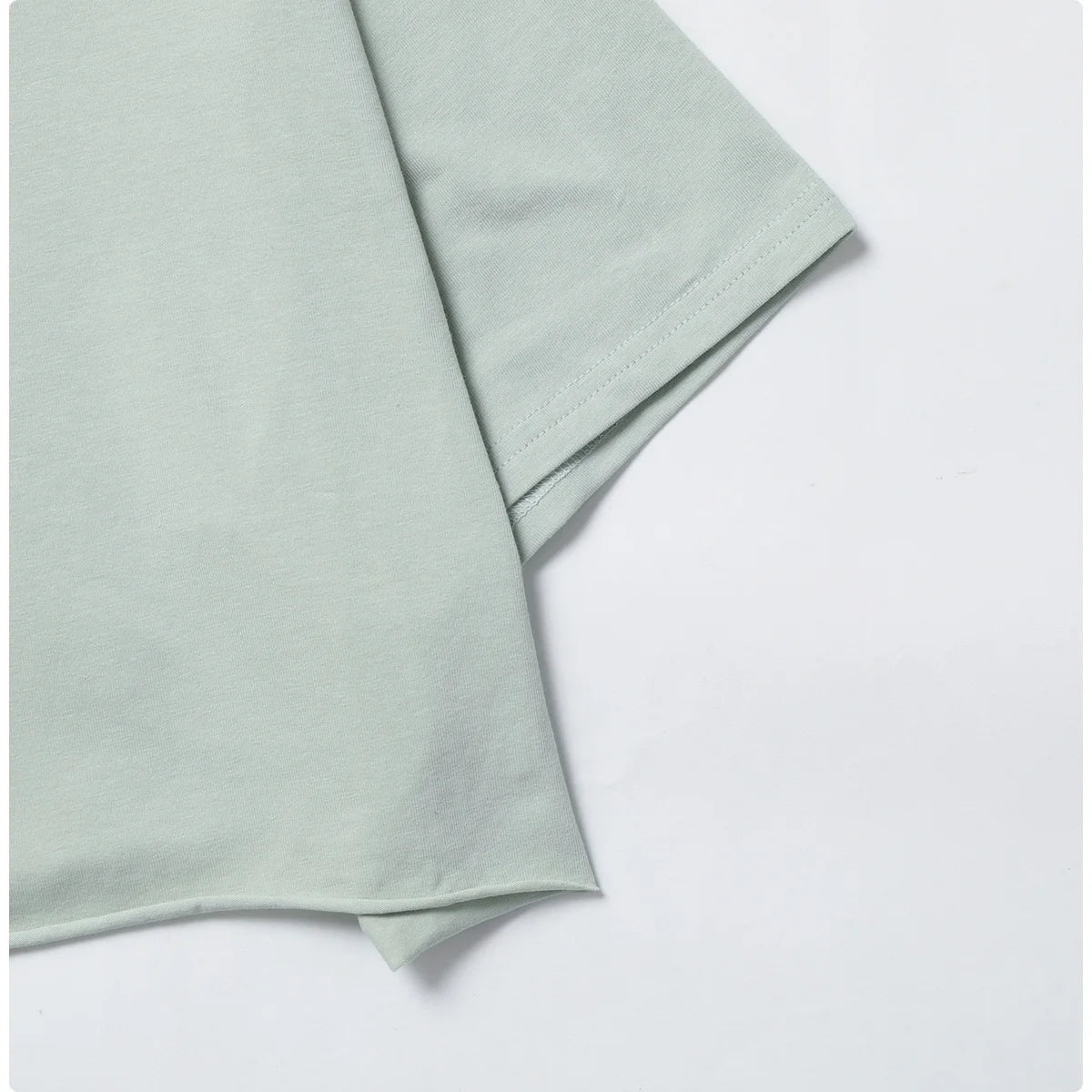 Stylish and comfortable NCLAGEN Casual T-shirt in a soft pastel hue, crafted from breathable cotton and spandex. This loose-fitting crop top is perfect for yoga, dance, or running, offering unrestricted movement and quick-dry technology. Elevate