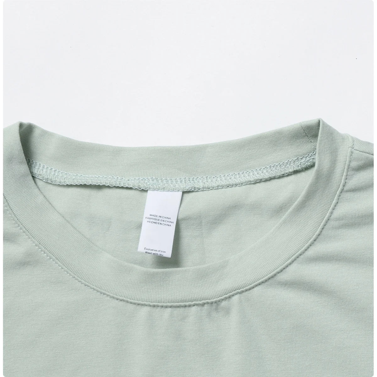 Stylish NCLAGEN Casual T-shirt in a soothing green hue, crafted from soft, breathable cotton and spandex for ultimate comfort. This loose-fit crop top is perfect for yoga, dance, or running, ensuring unrestricted movement. Experience quick-dry