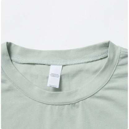 Stylish NCLAGEN Casual T-shirt in a soothing green hue, crafted from soft, breathable cotton and spandex for ultimate comfort. This loose-fit crop top is perfect for yoga, dance, or running, ensuring unrestricted movement. Experience quick-dry