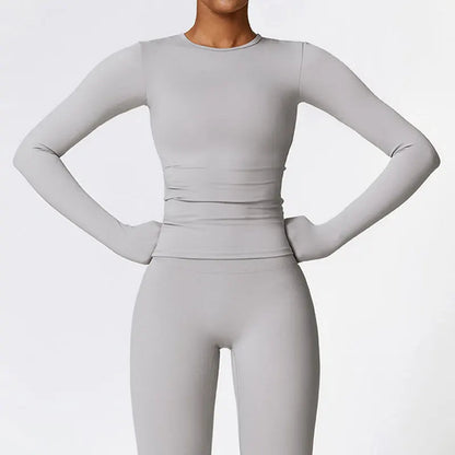 Elevate your activewear collection with the NCLAGEN Yoga Shirt! This stylish long-sleeve top features a quick-dry, breathable nylon and spandex blend, ensuring maximum comfort during workouts. The flattering slim fit enhances your silhouette, making it