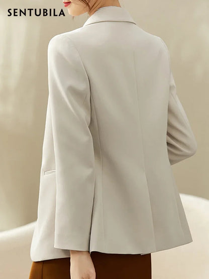 Beige blazer worn by a person on a beige background,