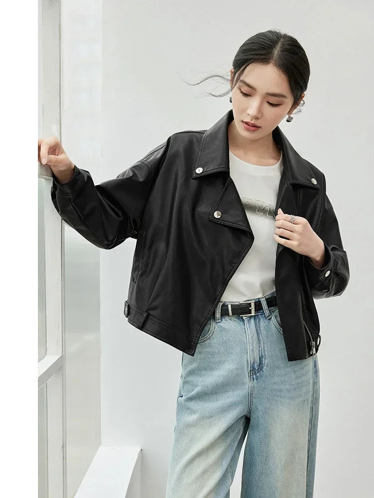 Woman wearing a black jacket and light blue jeans against a white background, with 'SENTUBILA' branding.