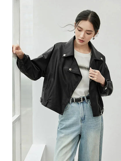 Woman wearing a black jacket and light blue jeans against a white background, with 'SENTUBILA' branding.