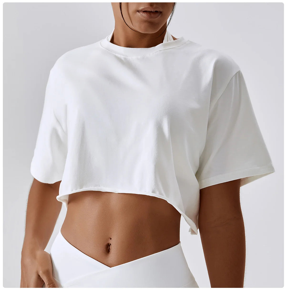 Stylish NCLAGEN Casual T-shirt in classic white, crafted from soft, breathable cotton and spandex. This chic crop top features a loose fit for unrestricted movement, making it perfect for yoga, dance, or running. Enjoy quick-dry technology