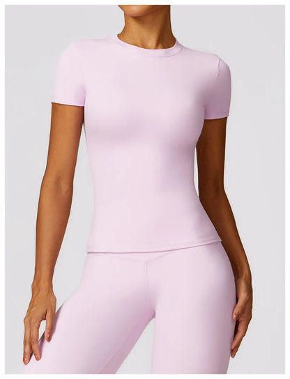 Elevate your fitness wardrobe with the NCLAGEN Short Sleeve T-Shirt in a stylish light pink hue. Crafted from lightweight, breathable nylon, this gym essential ensures ultimate comfort during workouts, yoga sessions, or casual outings. The fitted silhouette and round neck