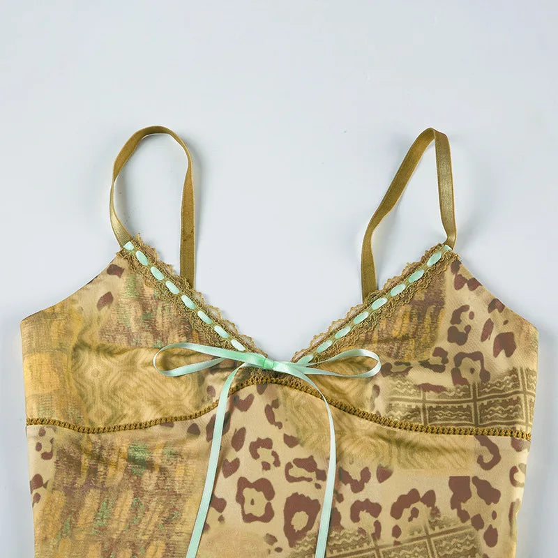 Discover the Gaono Y2K Vintage Women's Sleeveless Cami Top, a must-have addition to your summer wardrobe! This stylish camisole showcases a unique abstract print and a charming ribbon tie-up front, perfect for making a statement. Crafted from lightweight