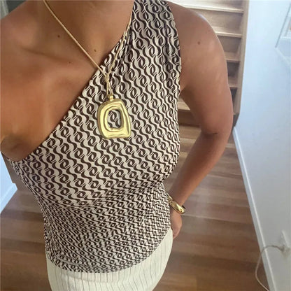 Elevate your summer style with the Gaono Floral Print Fitted Top! This chic one-shoulder tank features a vibrant floral design, perfect for resort wear or casual outings. Made from a soft cotton-polyester blend, it offers breathable comfort and