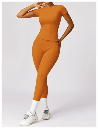 Elevate your activewear collection with the NCLAGEN Short Sleeve T-Shirt in a vibrant orange hue. Crafted from lightweight, breathable nylon, this fitted gym tee ensures ultimate comfort during workouts, yoga sessions, or casual outings. Its flattering round neck design