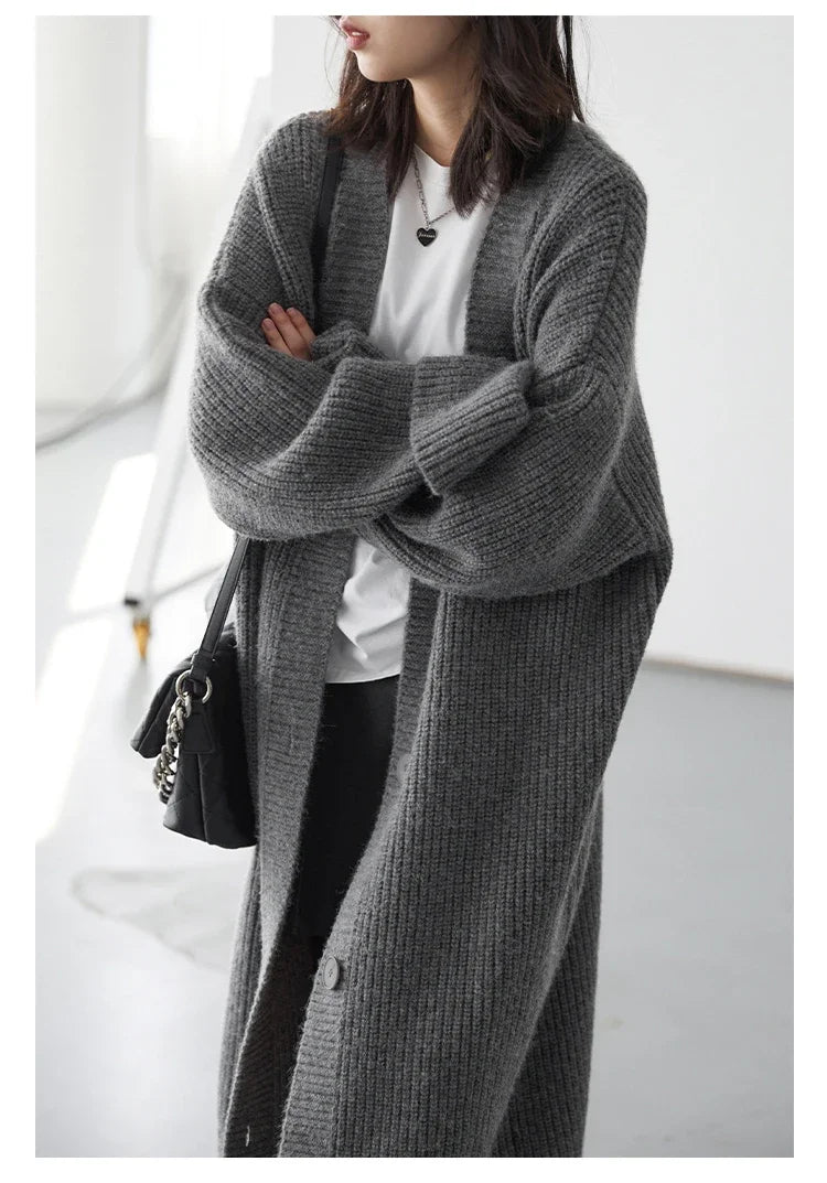 Effortlessly stylish Korean Loose Knitted Cardigan & Long Coat, crafted from luxuriously soft knitted fabric for ultimate comfort. This oversized fit offers a cozy silhouette that flatters every figure, making it perfect for layering. Featuring a timeless button closure