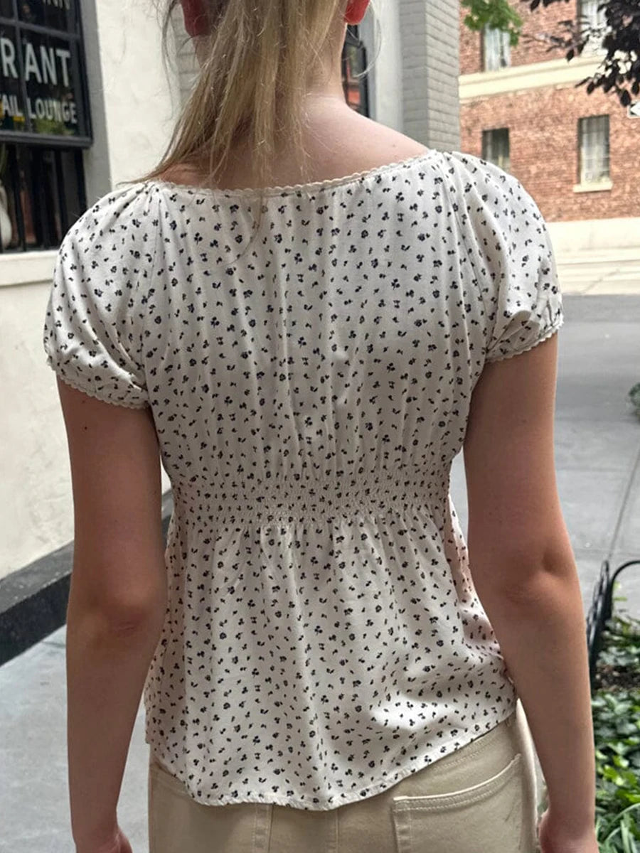 Discover the enchanting Gaono Y2K Fairy Cottage Vintage T-shirt, designed with a cute square collar and whimsical lace details. Made from a soft polyester and spandex blend, this T-shirt ensures all-day comfort while showcasing an adorable fairy tale pattern.