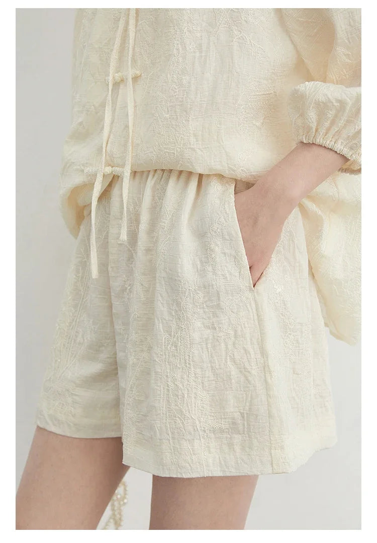 Discover the exquisite **Embroidered Chinese Blouse & Shorts Set**, a perfect blend of traditional artistry and modern elegance. Crafted from soft, breathable fabric, this outfit ensures comfort on warm days while its relaxed fit flatters every silhouette. The intricate embroidery