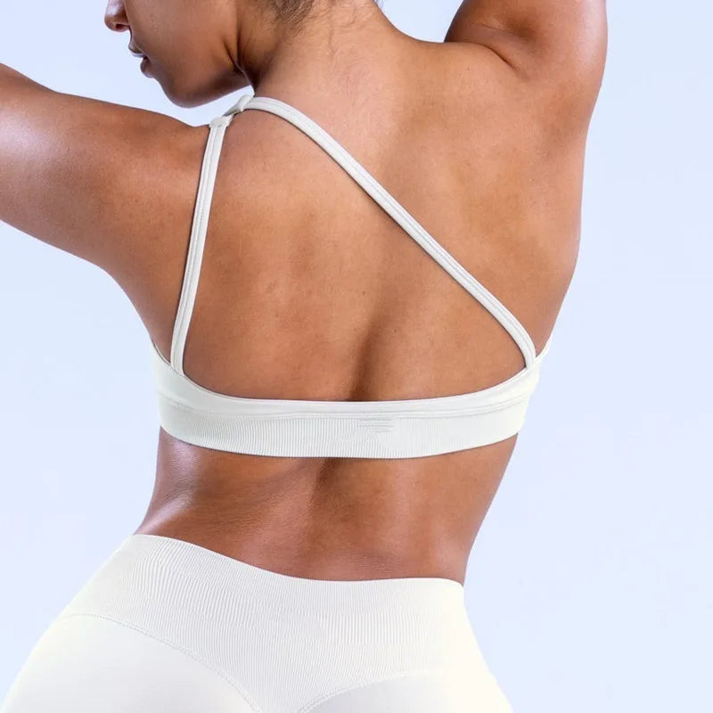 Elevate your workout wardrobe with the NCLAGEN Impact Asymmetric Sports Bra. This stylish high-support halter bra features a modern asymmetric design and a backless style, making it perfect for yoga and intense workouts. Crafted from quick-dry, breathable