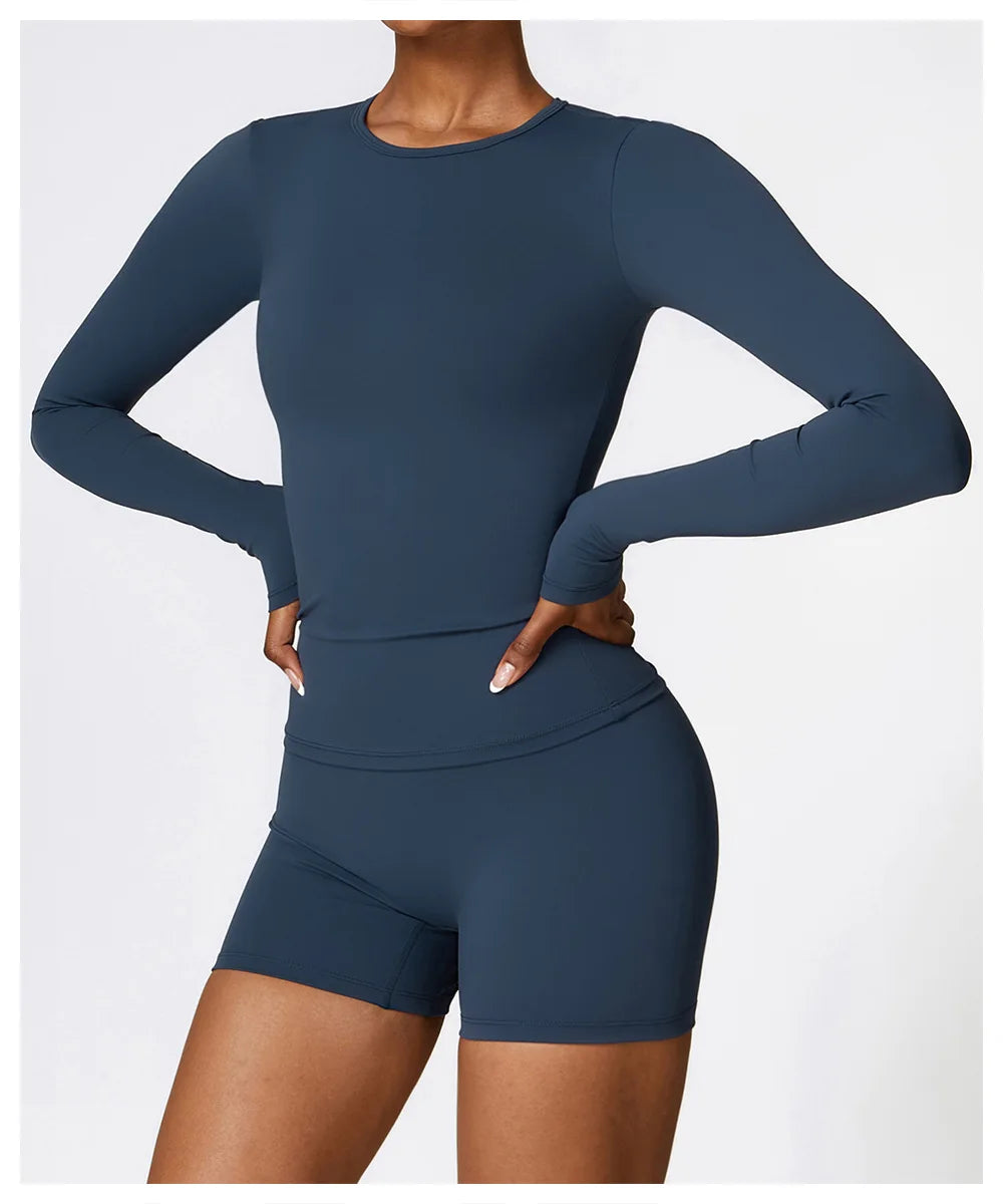 Discover the NCLAGEN Yoga Shirt, designed for the active woman who values both style and performance. This long-sleeve top features a quick-dry, breathable nylon and spandex blend, ensuring comfort during yoga, running, or gym workouts.