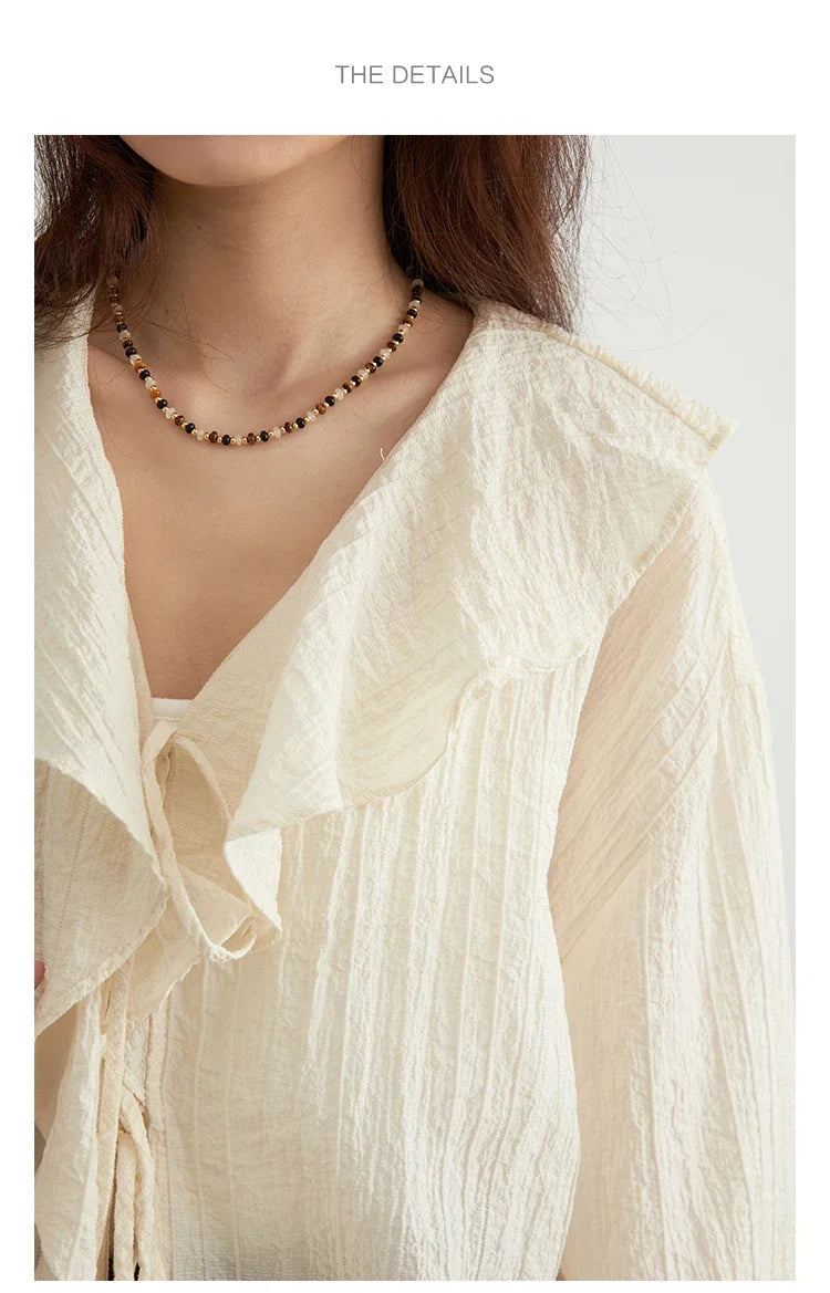 Effortlessly chic Ruffled V-Neck Lace-Up Blouse, perfect for spring and summer. Featuring a beautiful ruffled neckline, playful lace-up detailing, and a loose fit for ultimate comfort. Available in versatile colors, this blouse transitions seamlessly from
