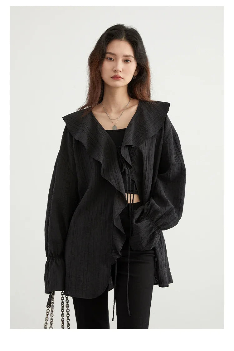 Chic Ruffled V-Neck Lace-Up Blouse in versatile black, designed for effortless style and comfort. Featuring a beautiful ruffled neckline and playful lace-up detailing, this loose fit blouse ensures breathability for warm days. Perfect for transitioning from day