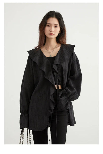Chic Ruffled V-Neck Lace-Up Blouse in versatile black, designed for effortless style and comfort. Featuring a beautiful ruffled neckline and playful lace-up detailing, this loose fit blouse ensures breathability for warm days. Perfect for transitioning from day